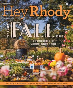Cover of the Hey Rhody Fall Issue featuring a pumpkin and hay bale display with autumn flowers at a farm festival.